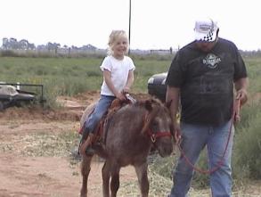 The youngest, Hannah who is not a horse person. Dan is leading Red for a short ride.