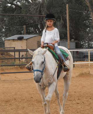 Erin on Jody trying horseback riding before going on a trail ride June 09