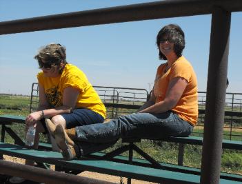 Two of the moms kicking back and enjoying each other's company at the arena while their girls ride.